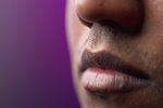 Close up of South Asian man lips against purple background.jpg