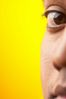 Close up of half of South Asian man face against yellow backgr 1.jpg