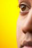 Close up of half of South Asian man face against yellow backgr 2.jpg