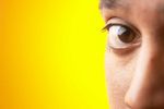 Close up of half of South Asian man face against yellow backgr 4.jpg