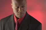 Frowning businessman in black suit.jpg