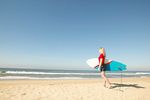 Girl carrying surfboard uid 1430352.jpg