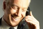 Laughing businessman talking on telephone.jpg