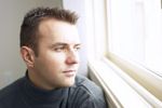 Man looking out of window c102126.jpg