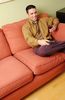 Man watching television and drinking glass of red wine.jpg
