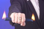 Person holding a candle burning at both ends c102724.jpg