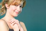 Smiling blonde with hands clasped together.jpg