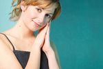Smiling blonde with hands held to cheek.jpg