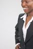 Smiling businesswoman in black suit 2.jpg