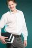 Smiling male adult holding books.jpg