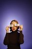 Surprised woman holding paper eyes to her face 1.jpg