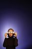 Surprised woman holding paper eyes to her face.jpg
