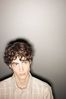 Teenaged boy against gray wall.jpg
