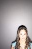 Teenaged girl standing against gray wall.jpg