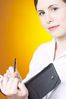 Thoughtful businesswoman writing in day planner.jpg