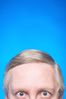 Top half of elderly Caucasian man face against blue background 2.jpg