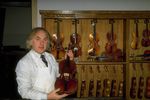 Violin maker displaying violins.jpg
