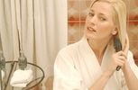 Woman brushing her hair in bathroom window.jpg