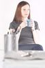 Woman drinking mug of coffee at her desk.jpg