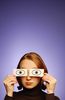 Woman holding paper eyes over her face.jpg