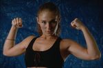 Woman in black swimsuit flexing biceps.jpg