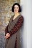 Woman leaning against white column.jpg