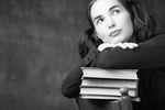 Woman leaning on pile of books.jpg