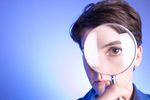 Woman looking through magnifying glass.jpg