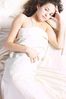 Woman lying in white bed sheets 2.jpg
