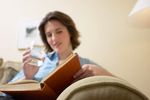 Woman reading book and drinking glass of water 1.jpg