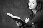 Woman reading book in wooden chair 1.jpg