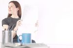 Woman reading newspaper at her desk 6.jpg