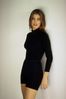 Woman standing against white wall.jpg