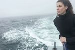 Woman standing on edge of boat uid 1283631.jpg