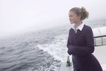 Woman standing on edge of sailboat.jpg
