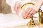Woman testing bath water temperature 1.jpg