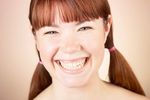 Woman with bare shoulders smiling broadly.jpg