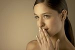 Young woman holding hand to mouth.jpg
